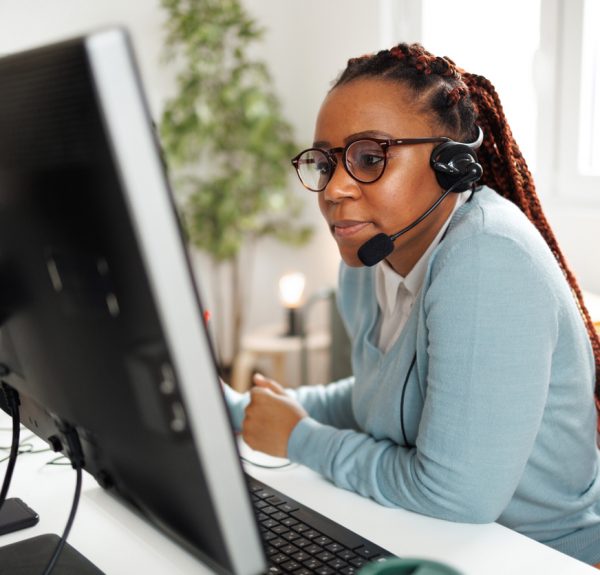 Shot of a young female call center agent working in the office